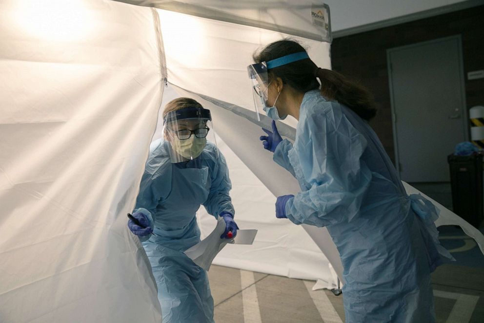 PHOTO: A nurse wearing protective clothing emerges from a tent a a coronavirus testing center at the University of Washington Medical center, March 13, 2020, in Seattle.