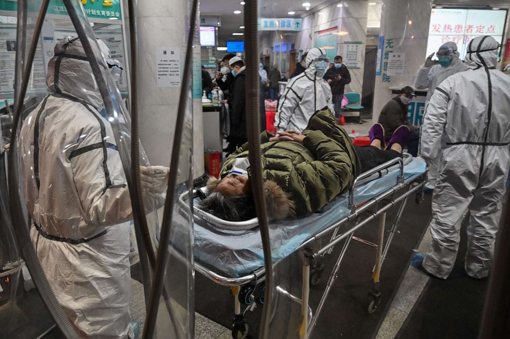PHOTO:Medical staff members wearing protective clothing to help stop the spread of a deadly virus which began in the city, arrive with a patient at the Wuhan Red Cross Hospital in Wuhan, China, Jan. 25, 2020. 