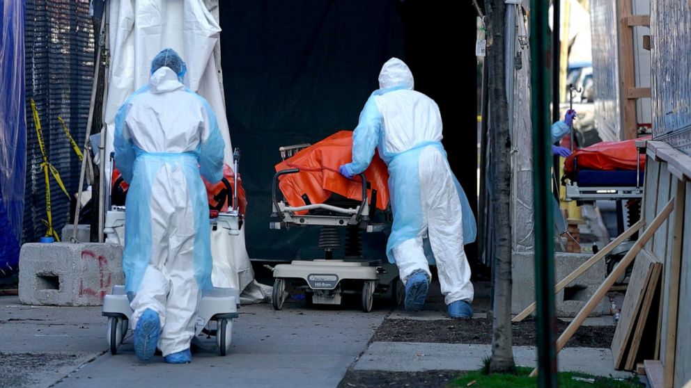 PHOTO: Bodies are moved to a refrigerator truck serving as a temporary morgue outside of Wyckoff Hospital in Brooklyn, April 4, 2020, in New York.