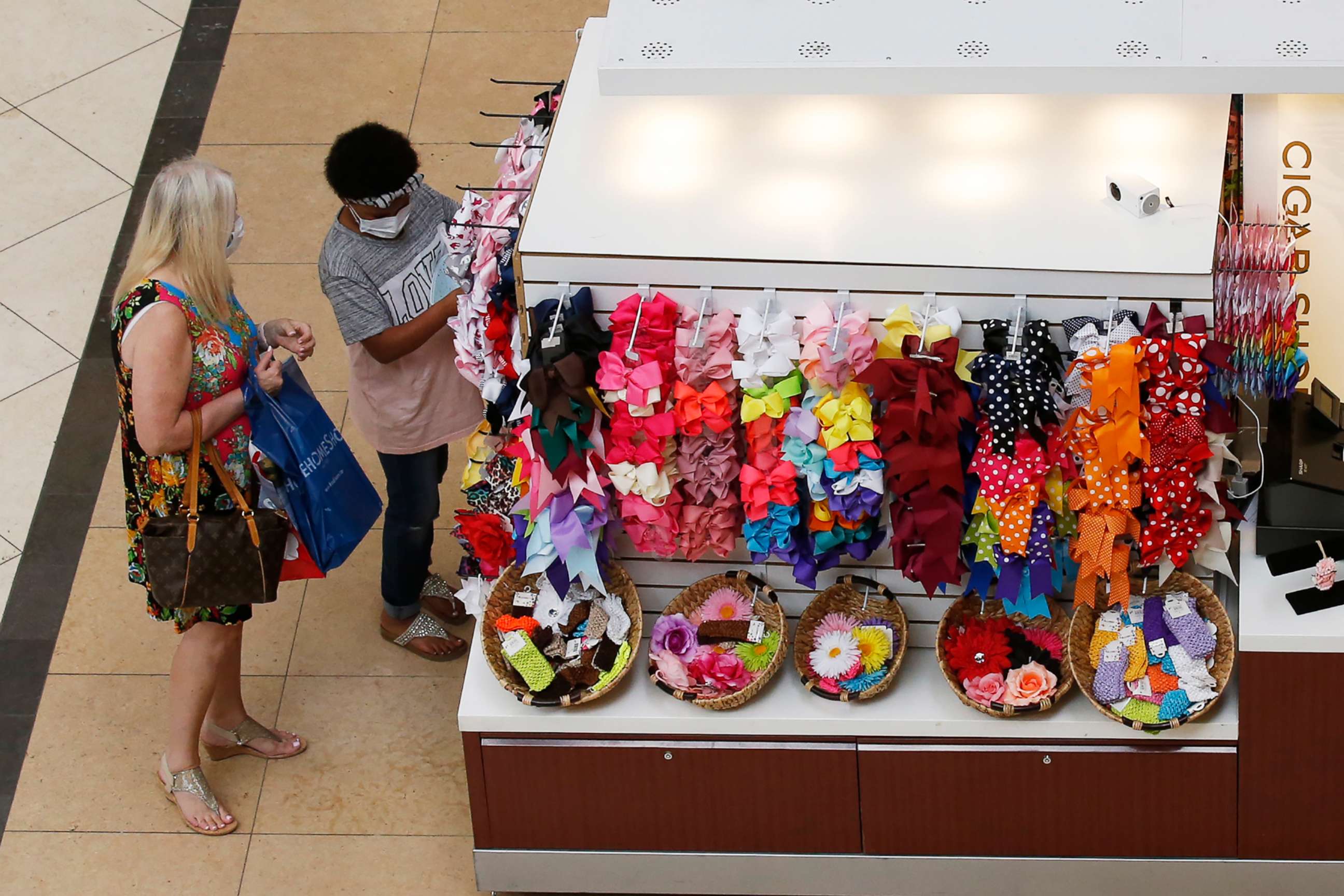 PHOTO: People shop at a kiosk at Penn Square Mall as the mall reopens, May 1, 2020, in Oklahoma City. 