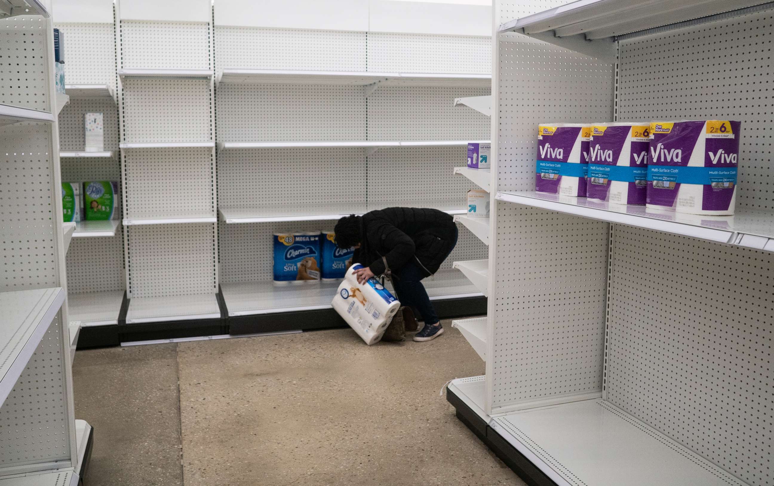 PHOTO: Deanna Butts reaches for one of the last packages of toilet paper at Target in the Tenleytown area of Washington, March 17, 2020.