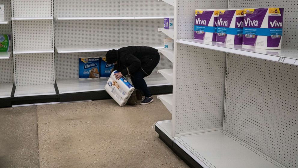 PHOTO: Deanna Butts reaches for one of the last packages of toilet paper at Target in the Tenleytown area of Washington, March 17, 2020.