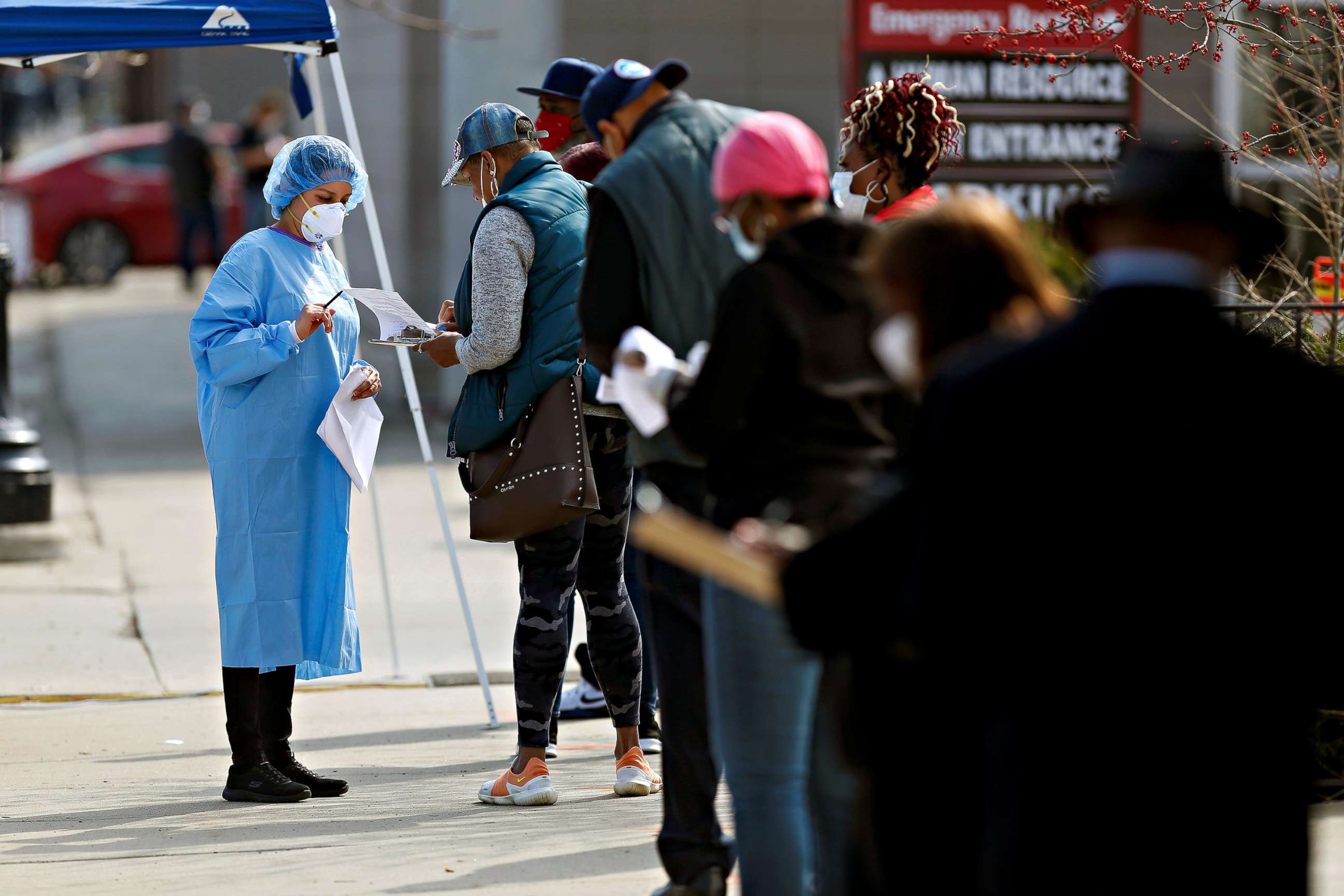 PHOTO: People wait in line to for coronavirus testing testing during outside Roseland Community Hospital in Chicago, April 7, 2020.