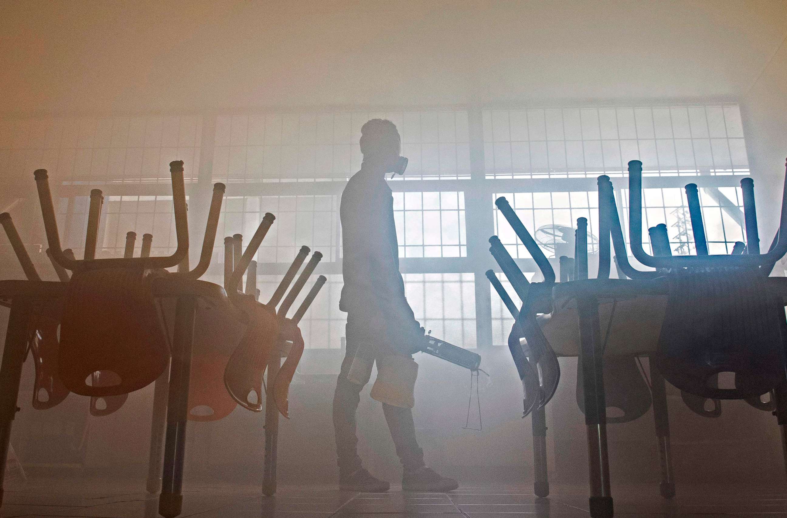 PHOTO: A worker uses a spray to disinfect the Reverend Francisco Schmitz School, in San Jose, Costa Rica, on March 12, 2020. The school will remain closed for 15 days, after one of its teachers was diagnosed with the coronavirus.