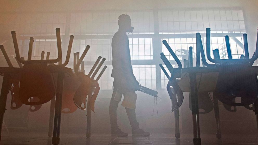 PHOTO: A worker uses a spray to disinfect the Reverend Francisco Schmitz School, in San Jose, Costa Rica, on March 12, 2020. The school will remain closed for 15 days, after one of its teachers was diagnosed with the coronavirus.