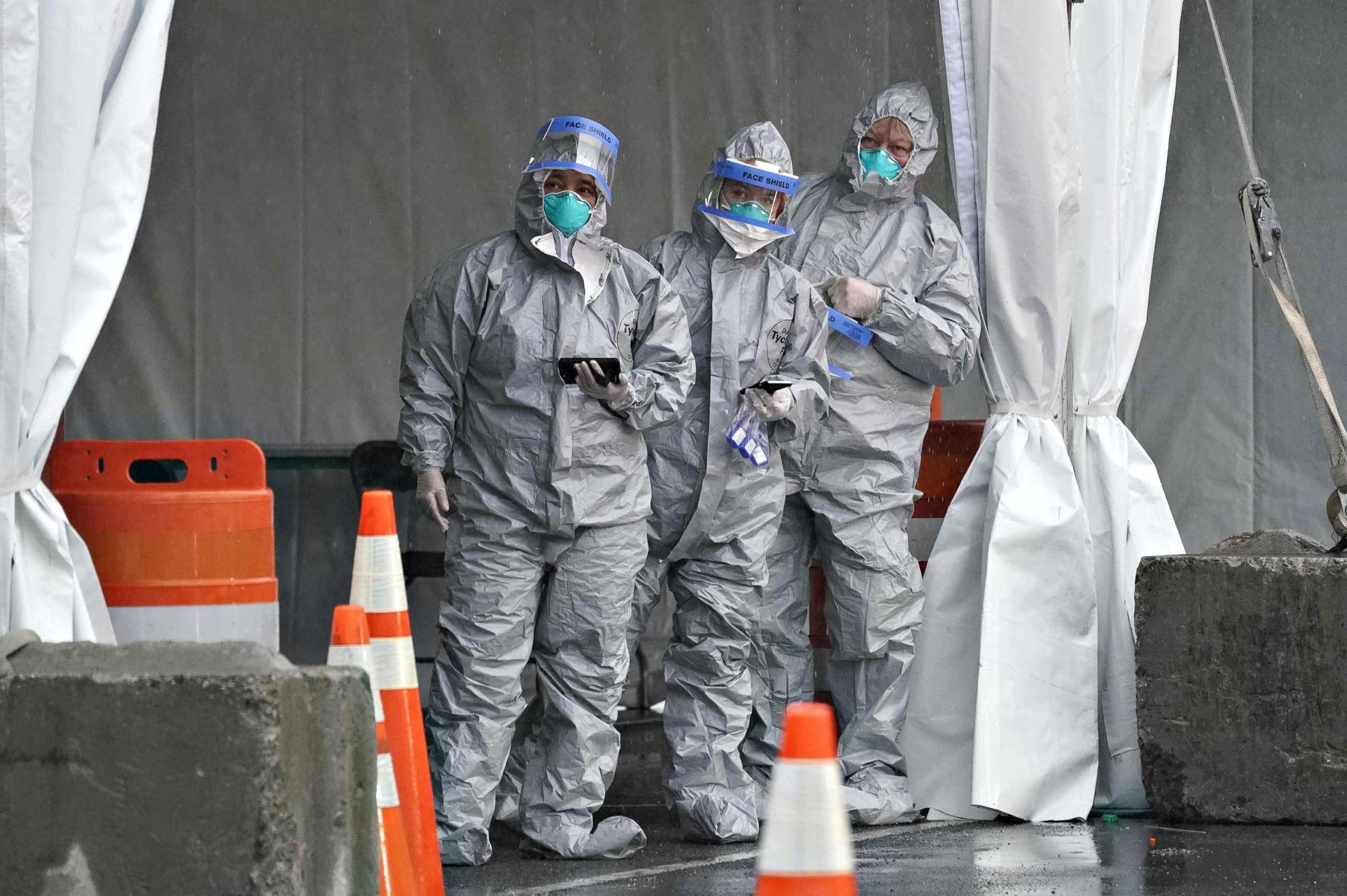 PHOTO: Workers in protective suits wait for people to arrive by car as Governor Andrew Cuomo opens the State's First Drive Through COVID-19 Mobile Testing Center at Glen Island Park, in New Rochelle, New York on March 13, 2020. 