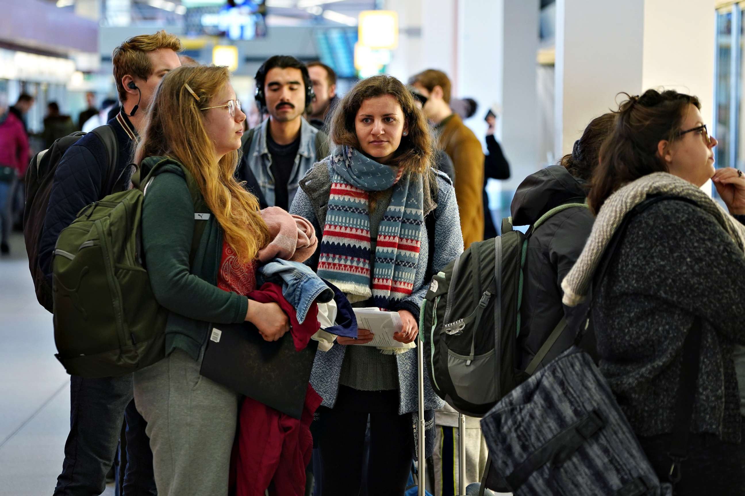 PHOTO: Passengers, including Aleksandra, left, from Poland and Sophia, center, from Germany wait to board the last direct United Airlines flight from Berlin to New York at Tegel Airport, in Berlin, March 13, 2020.