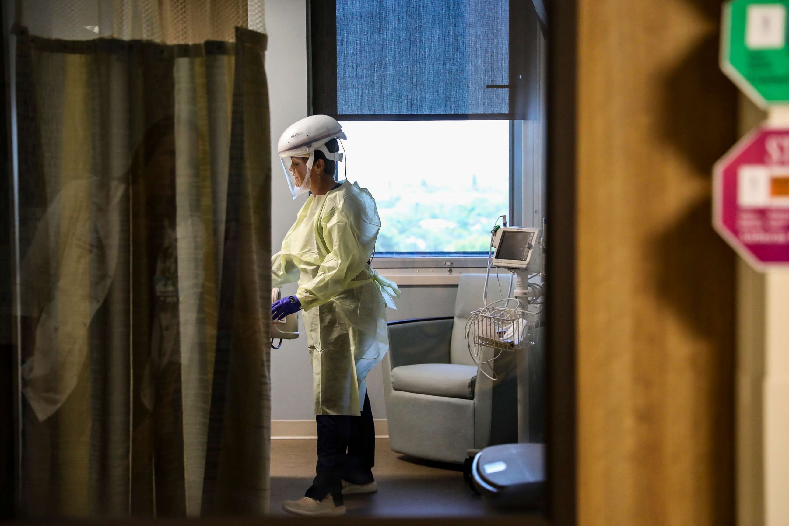 PHOTO: A nurse visits an isolated patient at Sarasota Memorial Hospital in Sarasota, Fla., March 10, 2020. 