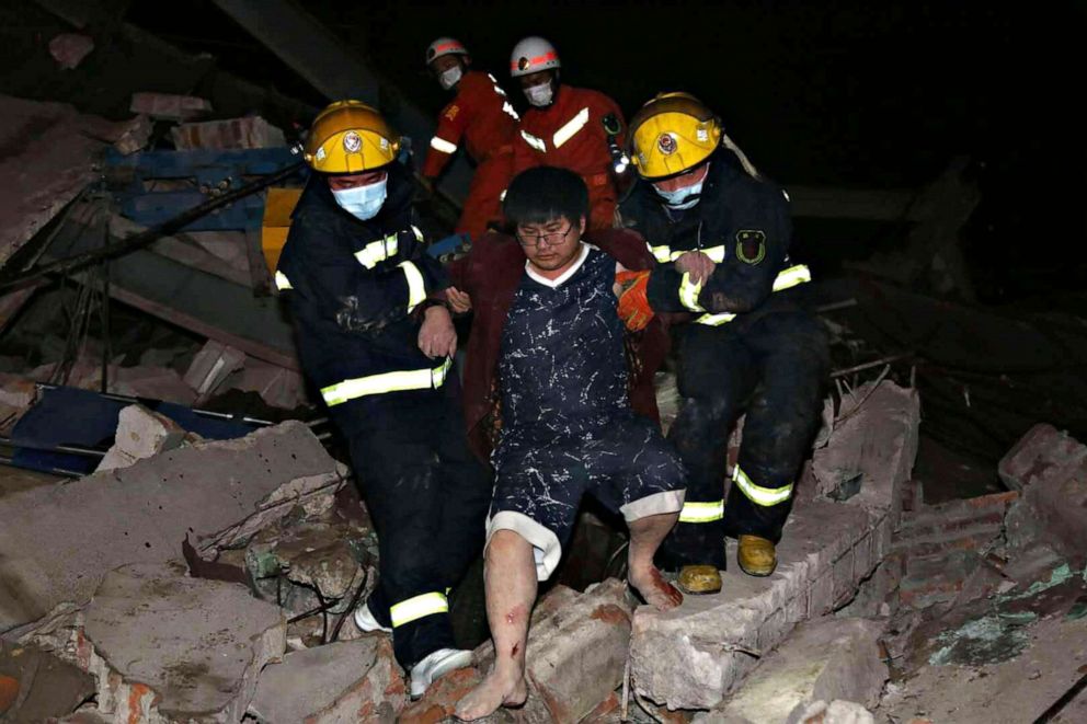 PHOTO:Rescuers help a man from the rubble of a collapsed hotel building in Quanzhou city in southeast China's Fujian province, March 7, 2020.