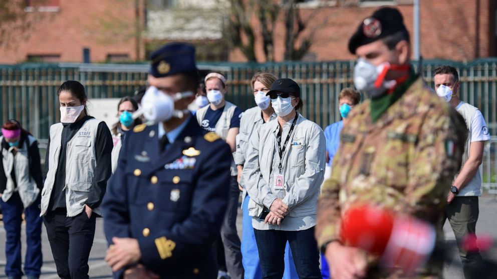 PHOTO: Italian soldiers and medical volunteers stand at attention during the opening of a newly operative field hospital for coronavirus patients, March 20, 2020, in Cremona, southeast of Milan.