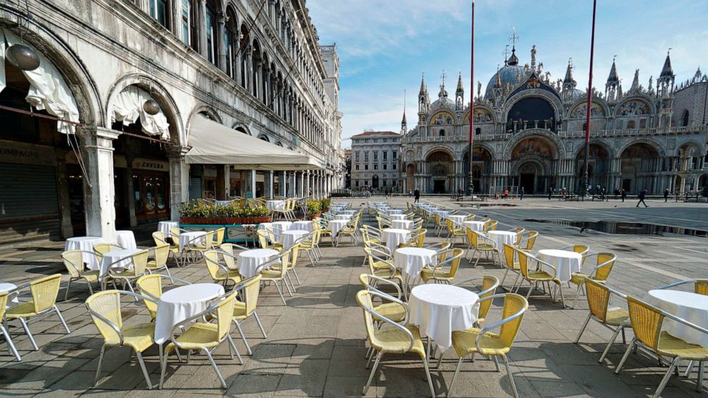 PHOTO: Empty chairs and tables are lined up outside a restaurant in St. Mark's Square in Venice, Italy, March 9, 2020.