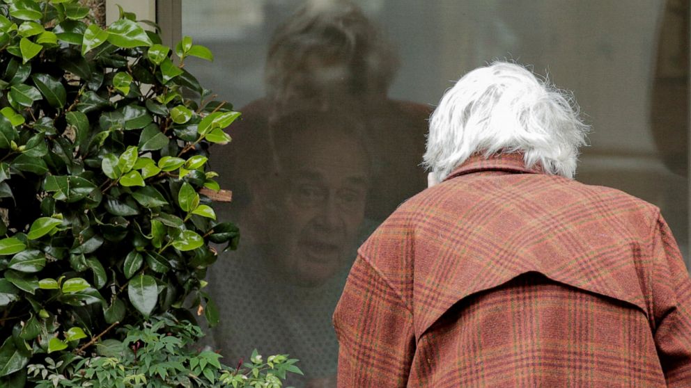 PHOTO: Gene Campbell talks through a window with his wife of more than 60 years, Dorothy Campbell, at the Life Care Center of Kirkland, in Kirkland, Washington, March 5, 2020.