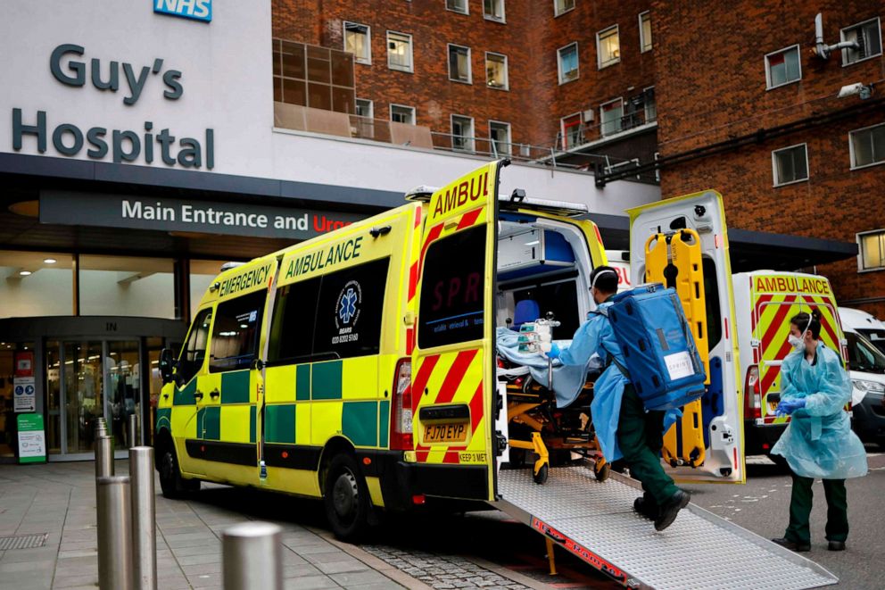 PHOTO: A patient on a gurney is taken from an ambulance parked outside Guy's Hospital in London on Dec. 29, 2020.