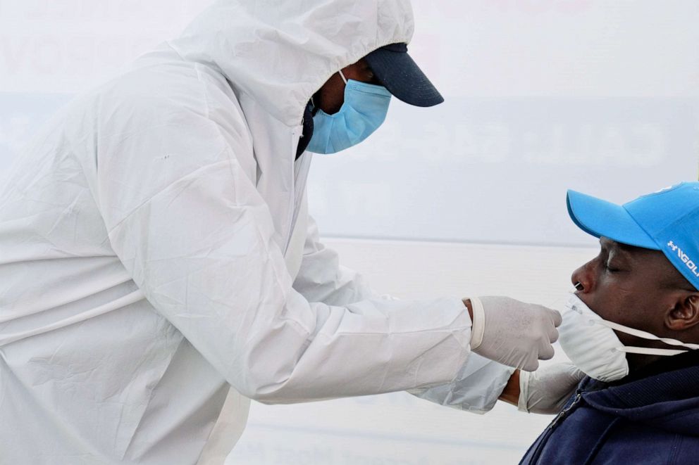 PHOTO: A health worker uses a nasal swab to test a man for COVID-19 in the Harlem neighborhood of New York City on April 20, 2020.