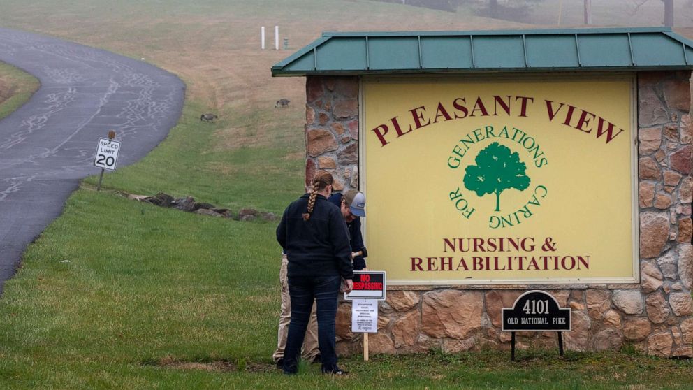 PHOTO: In the fog, Carroll County Health Department personnel place a "no trespassing" sign by the driveway of the Pleasant View Nursing Home, in Mount Airy, Md., Sunday, March 29, 2020.