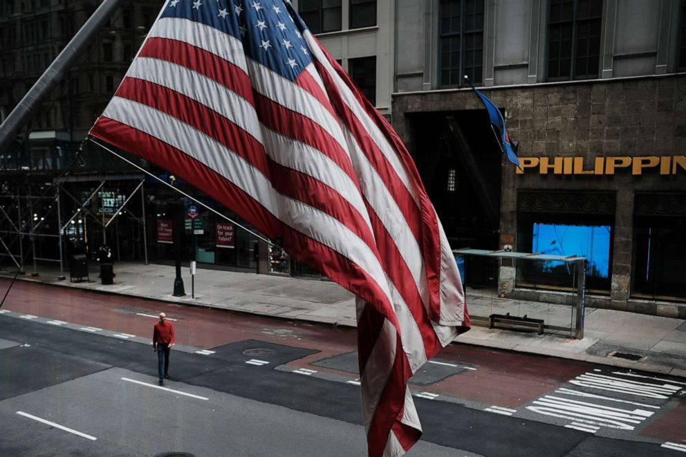 PHOTO: A man walks across a Midtown Manhattan street, March 17, 2020 in New York.