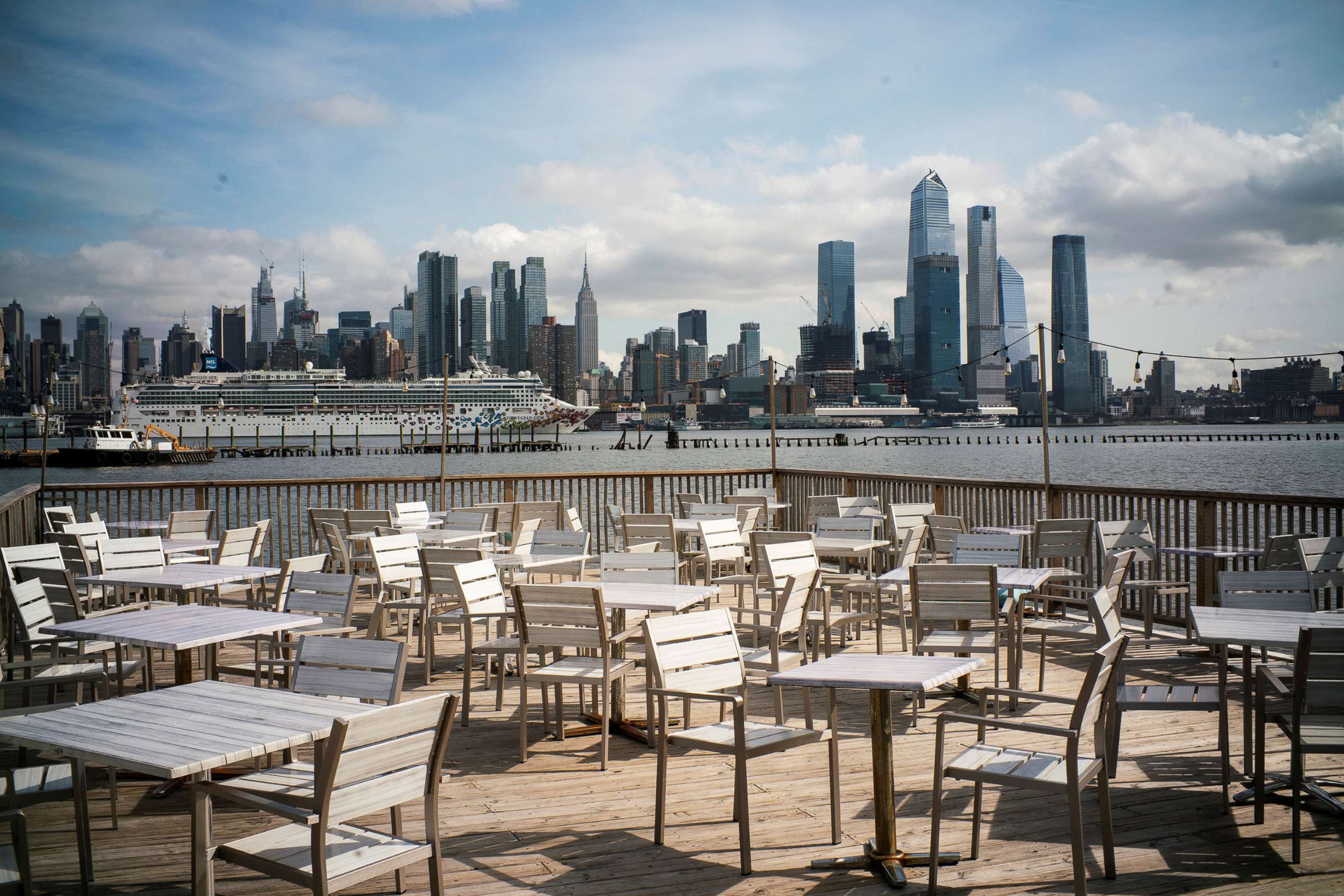 PHOTO: Empty chairs are seen at the deck of a local restaurant that is closed due to the outbreak of coronavirus disease (COVID-19), in Hoboken, N.J., March 16, 2020.