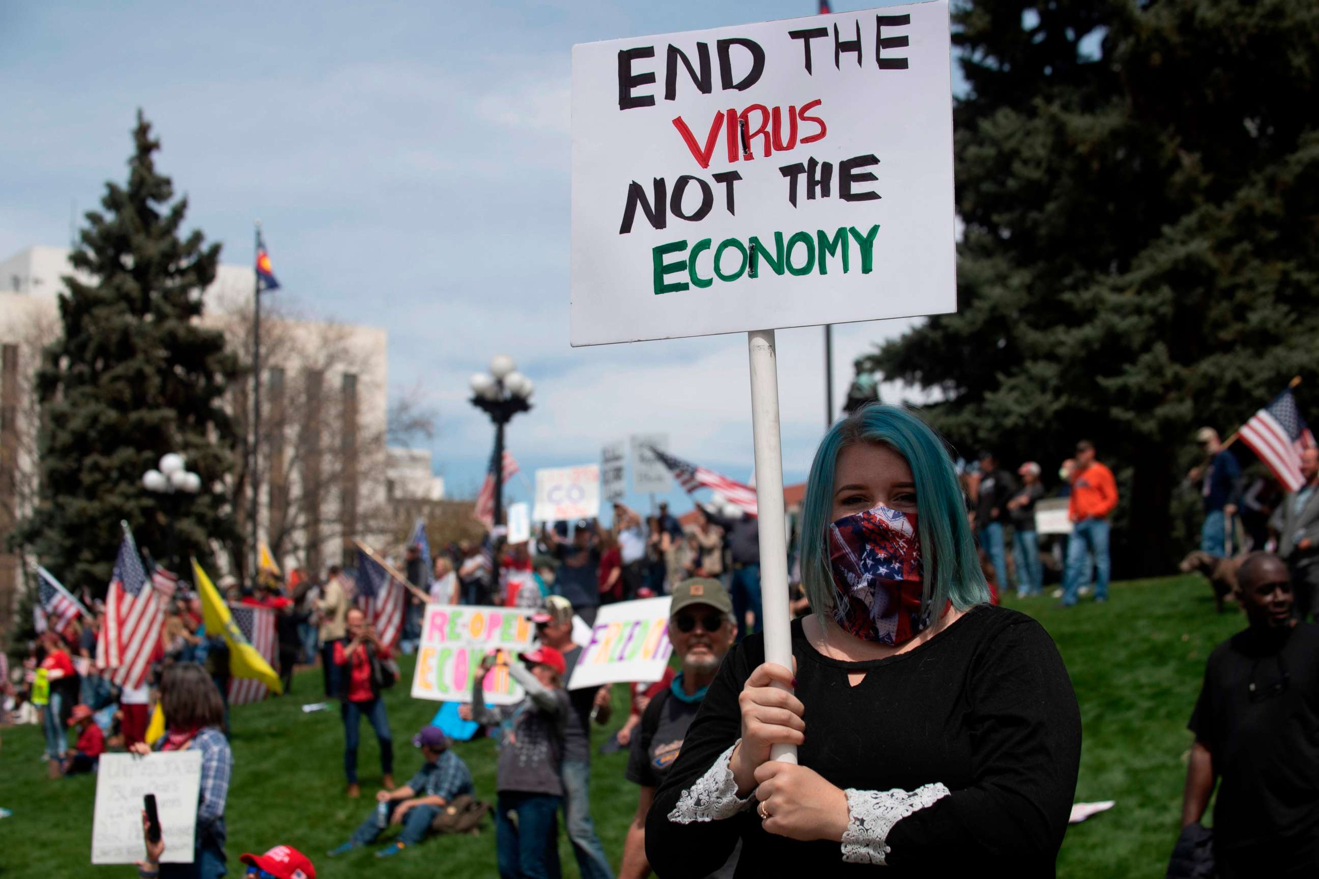 PHOTO: Demonstrators gather in front of the Colorado State Capitol building to protest coronavirus-related stay-at-home orders during a "ReOpen Colorado" rally in Denver, Colorado, on April 19, 2020.