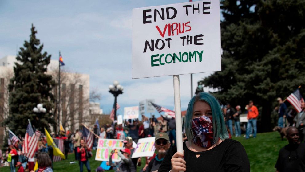 PHOTO: Demonstrators gather in front of the Colorado State Capitol building to protest coronavirus-related stay-at-home orders during a "ReOpen Colorado" rally in Denver, Colorado, on April 19, 2020.