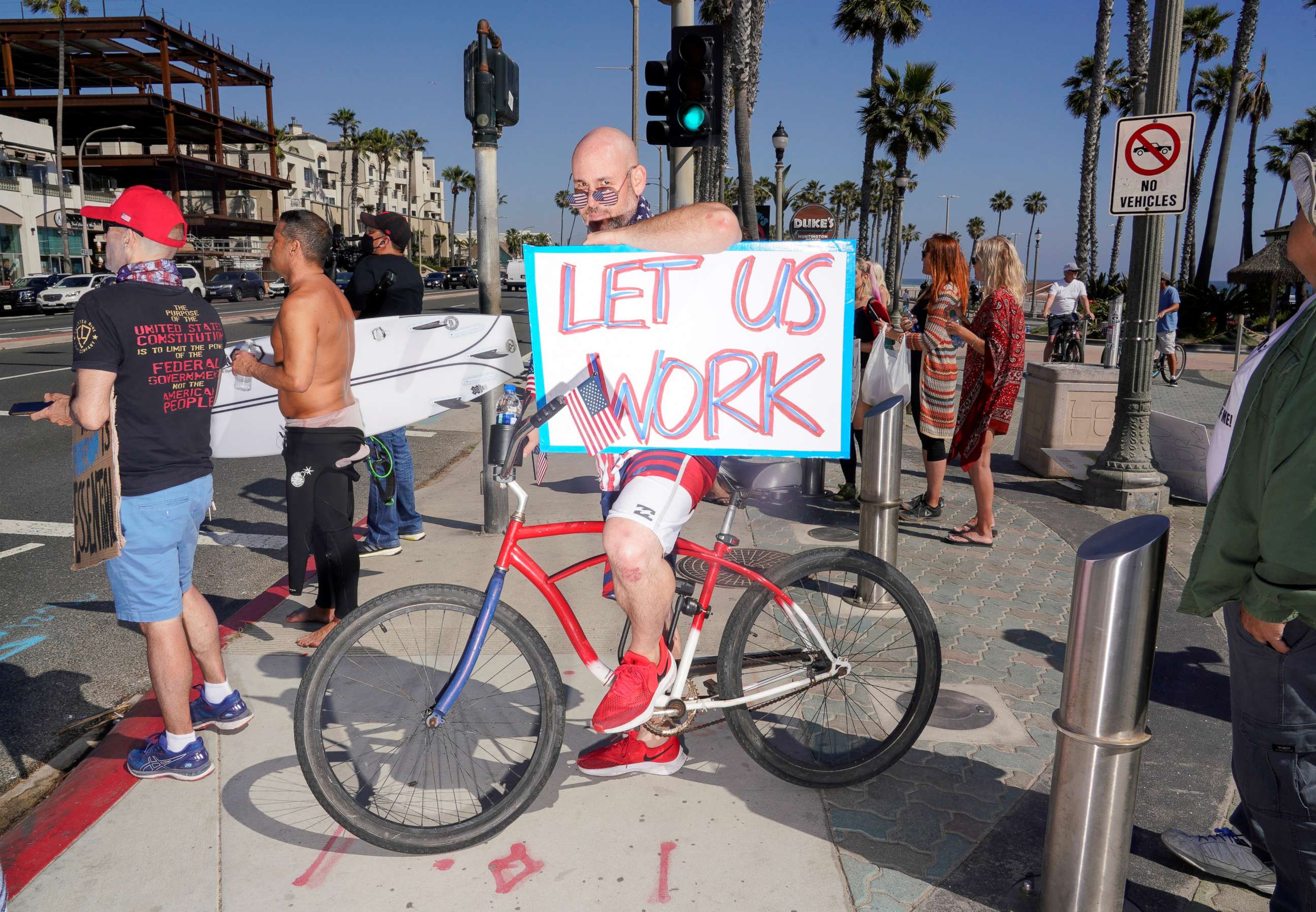 PHOTO: Levi Smiley of Huntington Beach, who has recently been furloughed, protests Gov. Gavin Newsom's order to temporarily close state and local beaches in Orange County, during the outbreak of COVID-19 in Huntington Beach, Calif., May 1, 2020. 