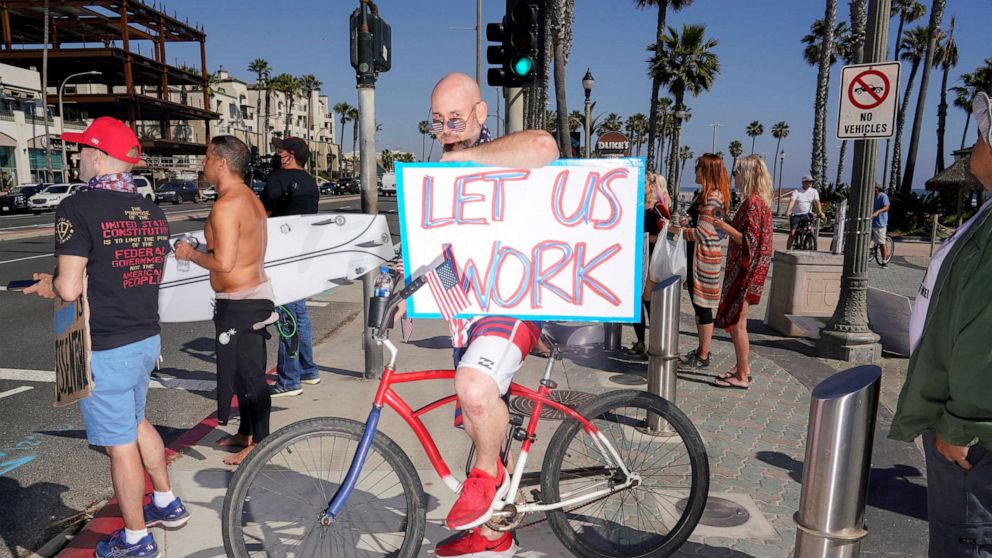 PHOTO: Levi Smiley of Huntington Beach, who has recently been furloughed, protests Gov. Gavin Newsom's order to temporarily close state and local beaches in Orange County, during the outbreak of COVID-19 in Huntington Beach, Calif., May 1, 2020. 
