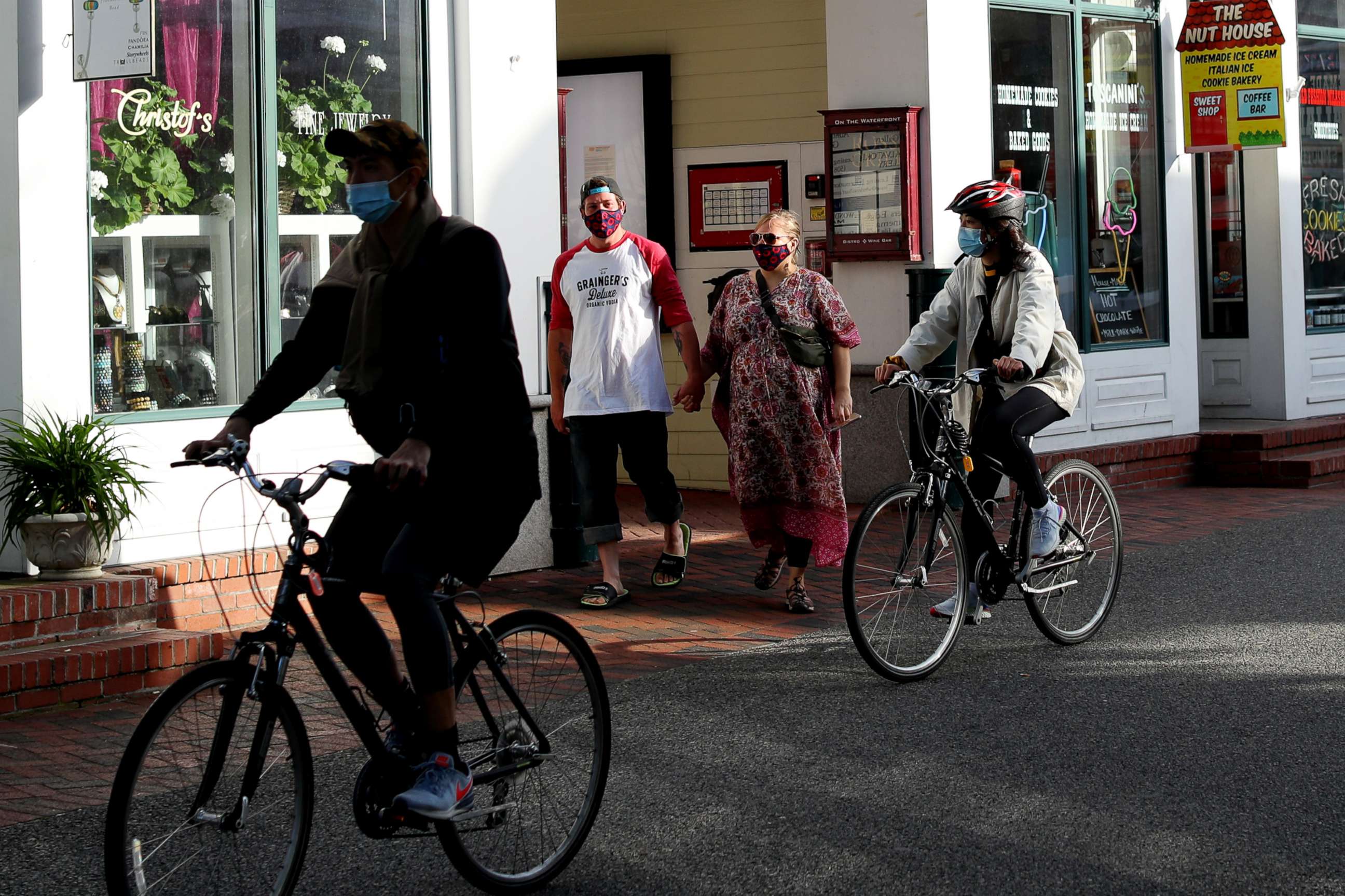 PHOTO: Pedestrians walk down Commercial Street on May 25, 2020, in Provincetown, Mass.