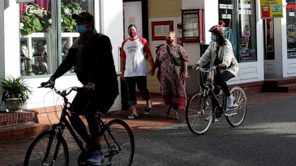 PHOTO: Pedestrians walk down Commercial Street on May 25, 2020, in Provincetown, Mass.