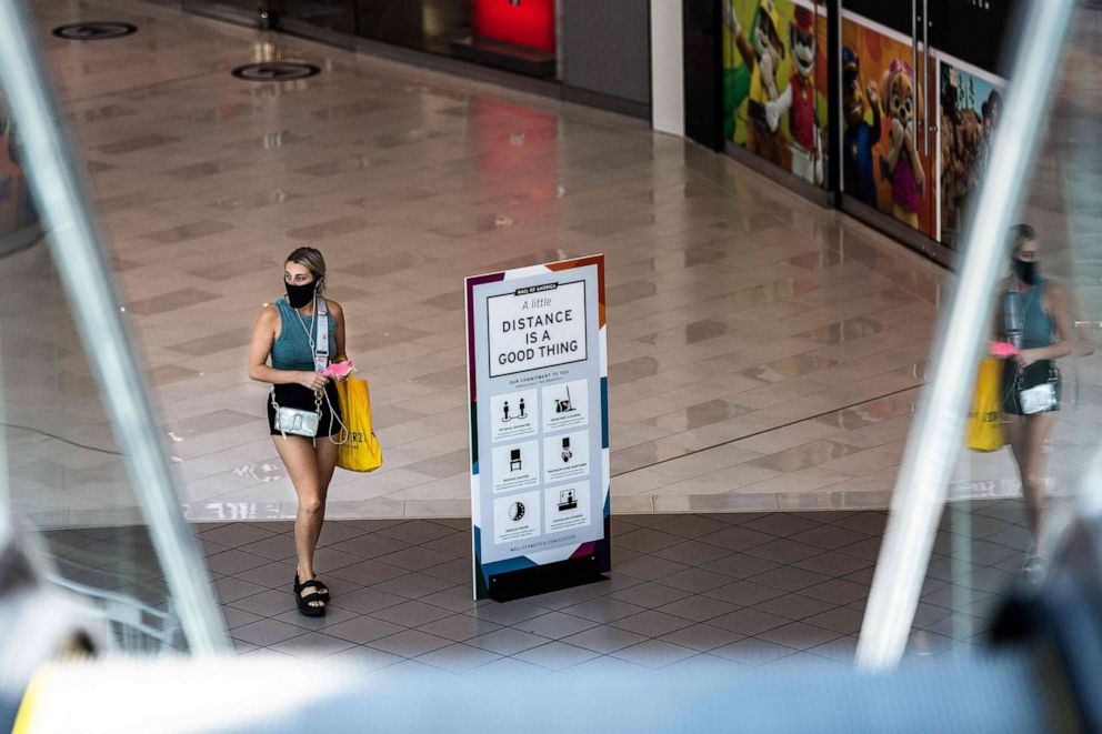 PHOTO: A shopper wearing a face mask walks through the Mall of America on June 16, 2020 in Bloomington, Minn.