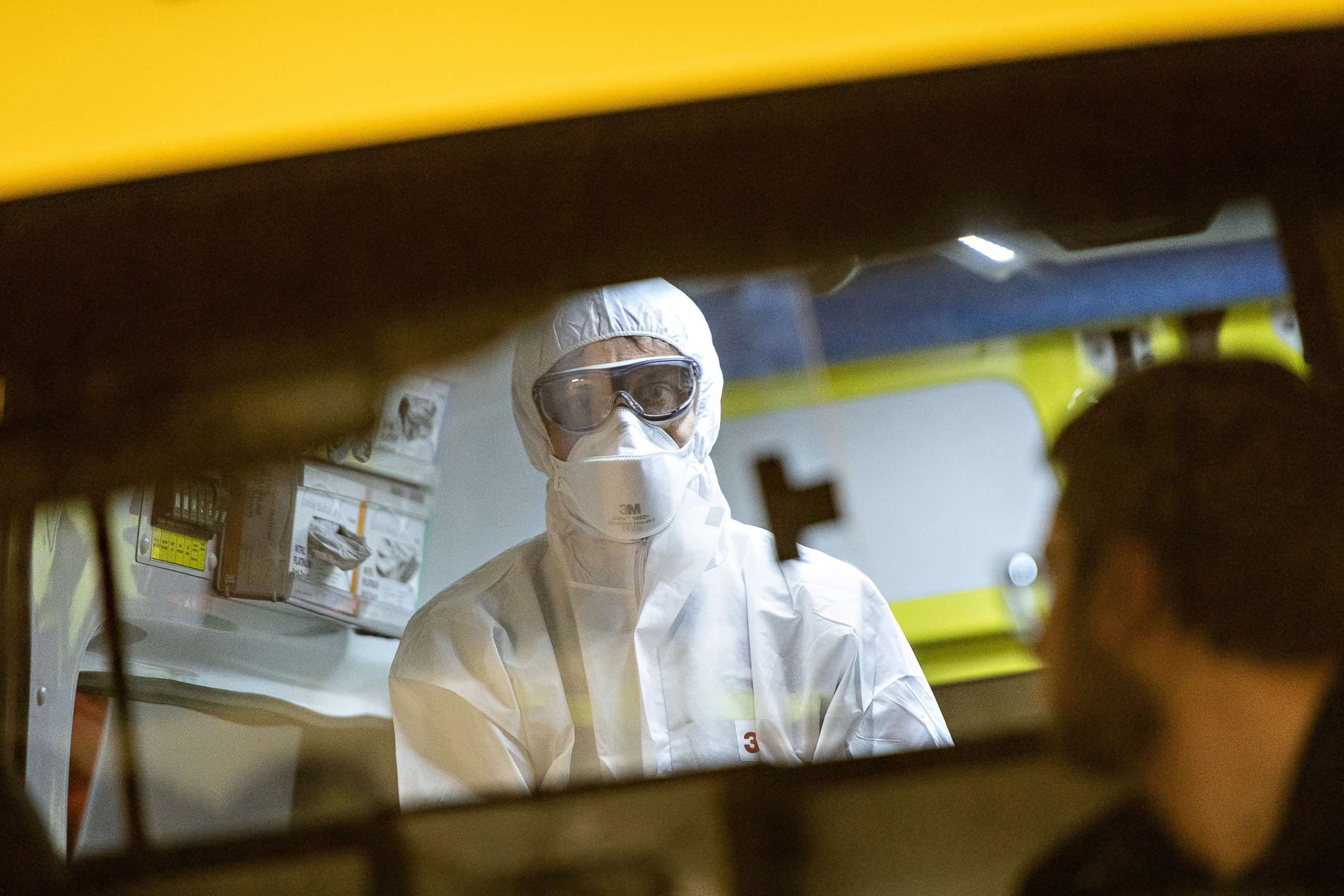 PHOTO:An ambulance health care worker of the Mendrisiotto Ambulance Service puts on his mask and protection gear to practice for an coronavirus emergency in Mendrision, Switzerland, Feb. 26, 2020.