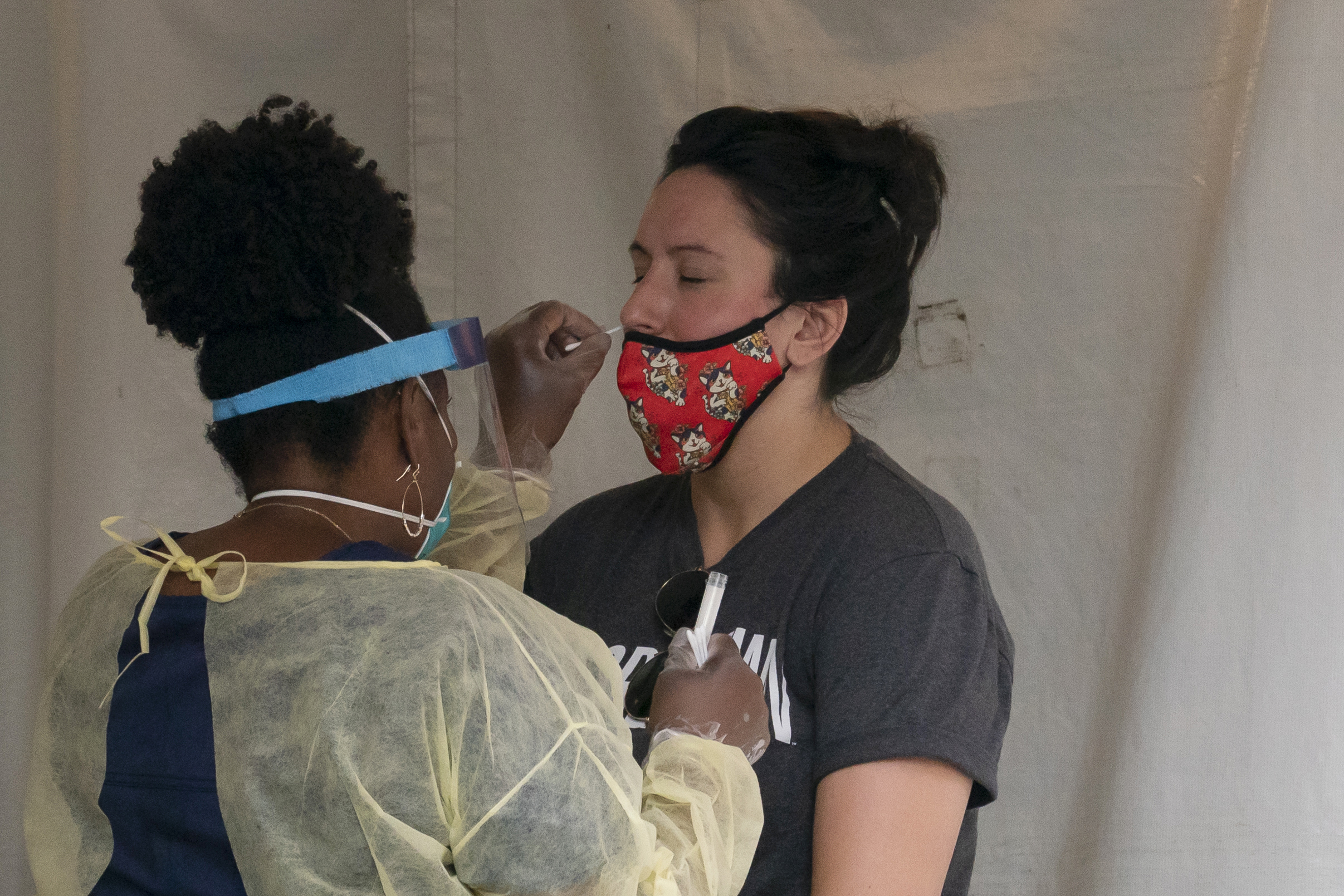 PHOTO: A nurse with the Washington, D.C. Dept. of Health, administers a COVID-19 test on F Street, Aug. 14, 2020, in Washington.