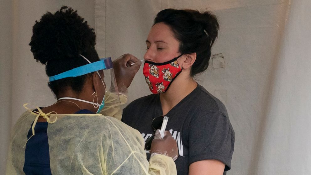 PHOTO: A nurse with the Washington, D.C. Dept. of Health, administers a COVID-19 test on F Street, Aug. 14, 2020, in Washington.