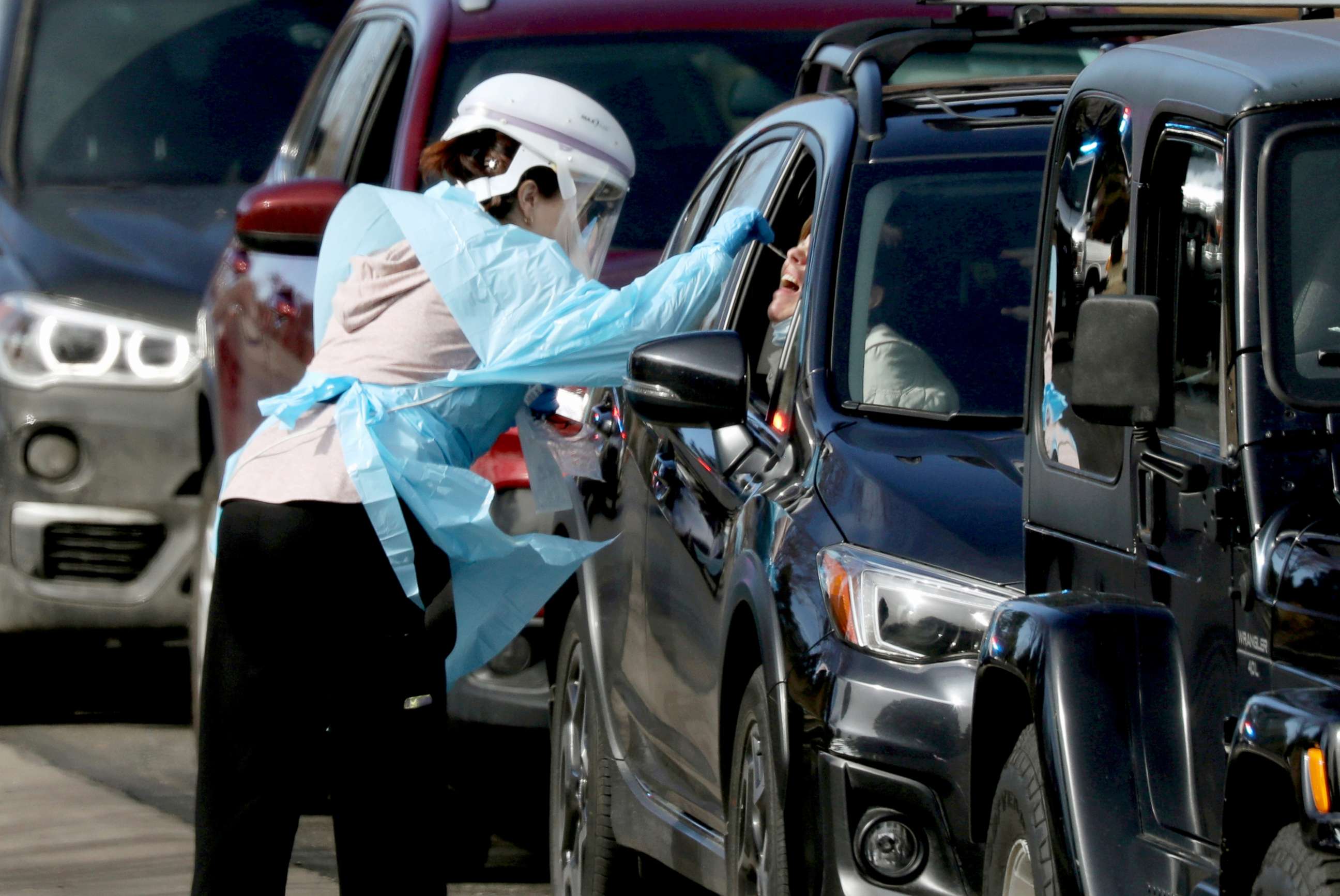 PHOTO: Health care worker tests people at a drive-thru testing station run by the state health department, for people who suspect they have novel coronavirus, in Denver, Colorado, March 11, 2020.