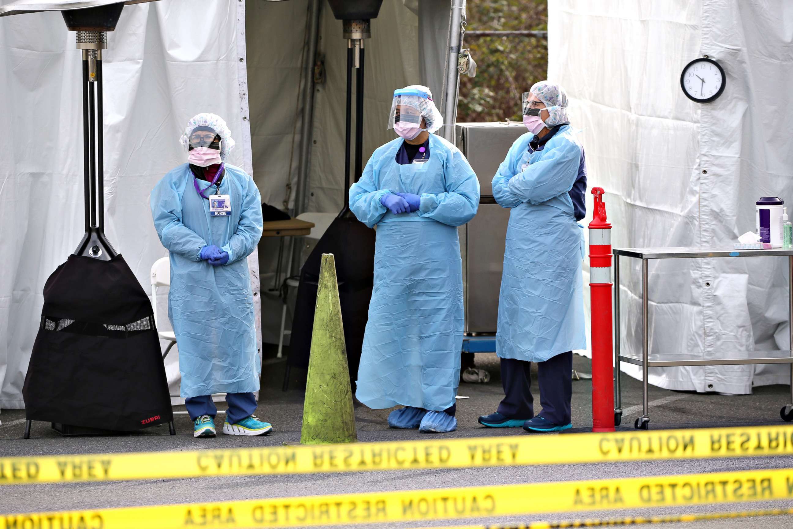 PHOTO: Nurses wait for a patient to arrive for a COVID-19 screening at an appointment-only drive-up clinic set up by the University of Washington Medical Center Northwest Outpatient Medical Center, on March 17, 2020 in Seattle.