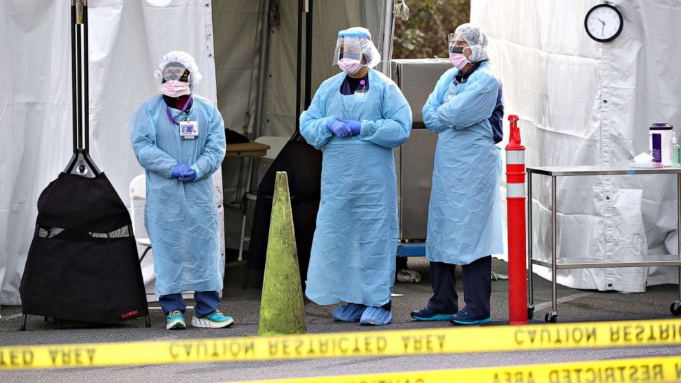 PHOTO: Nurses wait for a patient to arrive for a COVID-19 screening at an appointment-only drive-up clinic set up by the University of Washington Medical Center Northwest Outpatient Medical Center, on March 17, 2020 in Seattle.