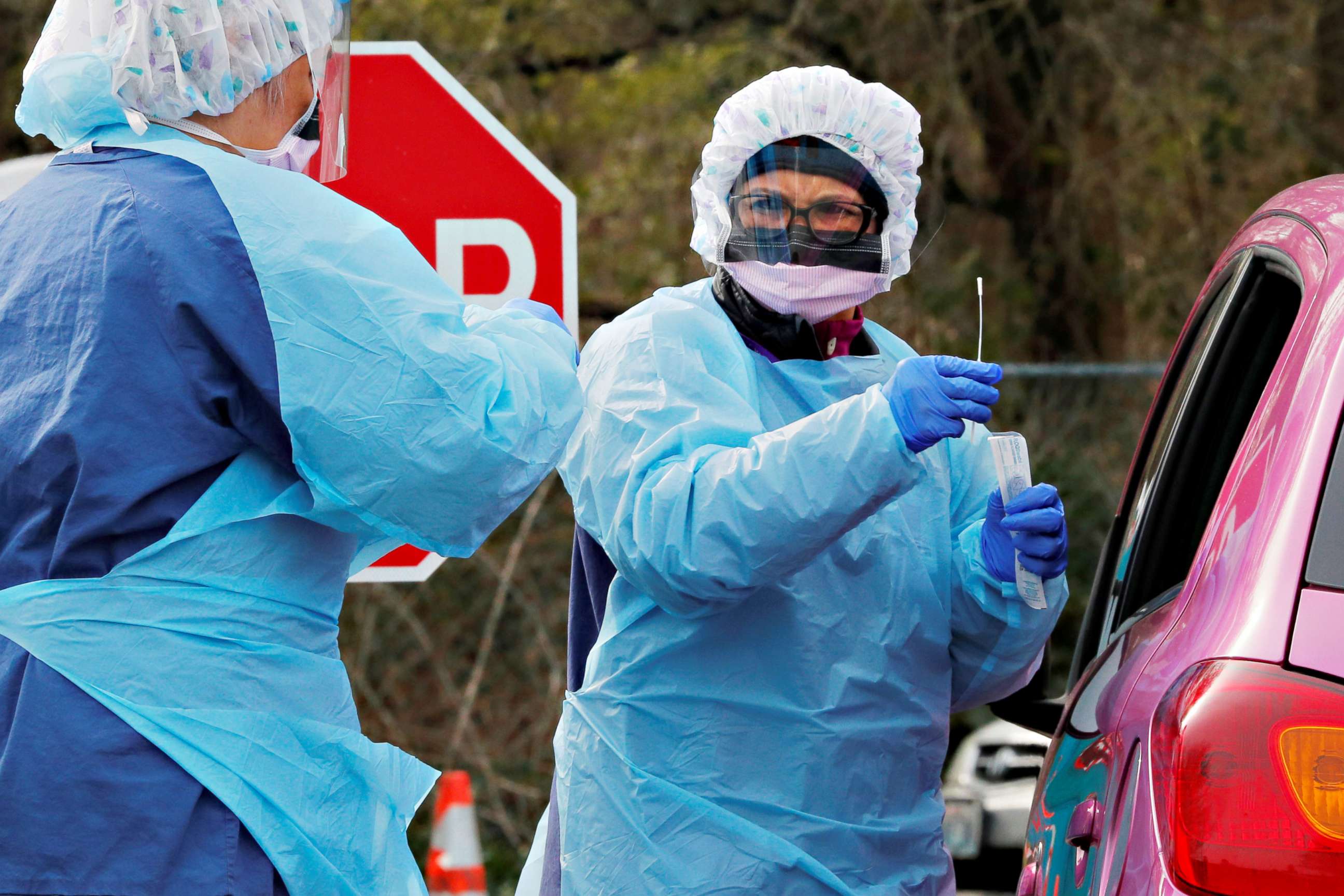 PHOTO: Nurse Corazon Morales administers a test for coronavirus disease (COVID-19) to a patient at a drive-through testing site in a parking lot at the University of Washington's Northwest Outpatient Medical Center in Seattle, March 17, 2020.