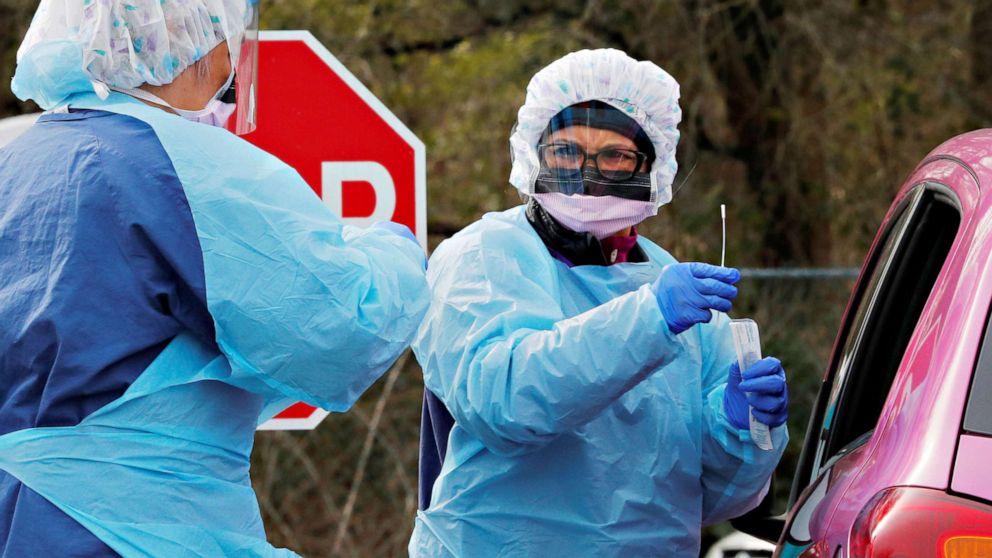 PHOTO: Nurse Corazon Morales administers a test for coronavirus disease (COVID-19) to a patient at a drive-through testing site in a parking lot at the University of Washington's Northwest Outpatient Medical Center in Seattle, March 17, 2020.