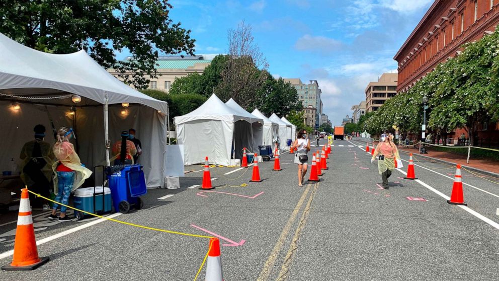 PHOTO: Health workers provide COVID-19 testing on a street in Washington, D.C., on Aug. 14, 2020.