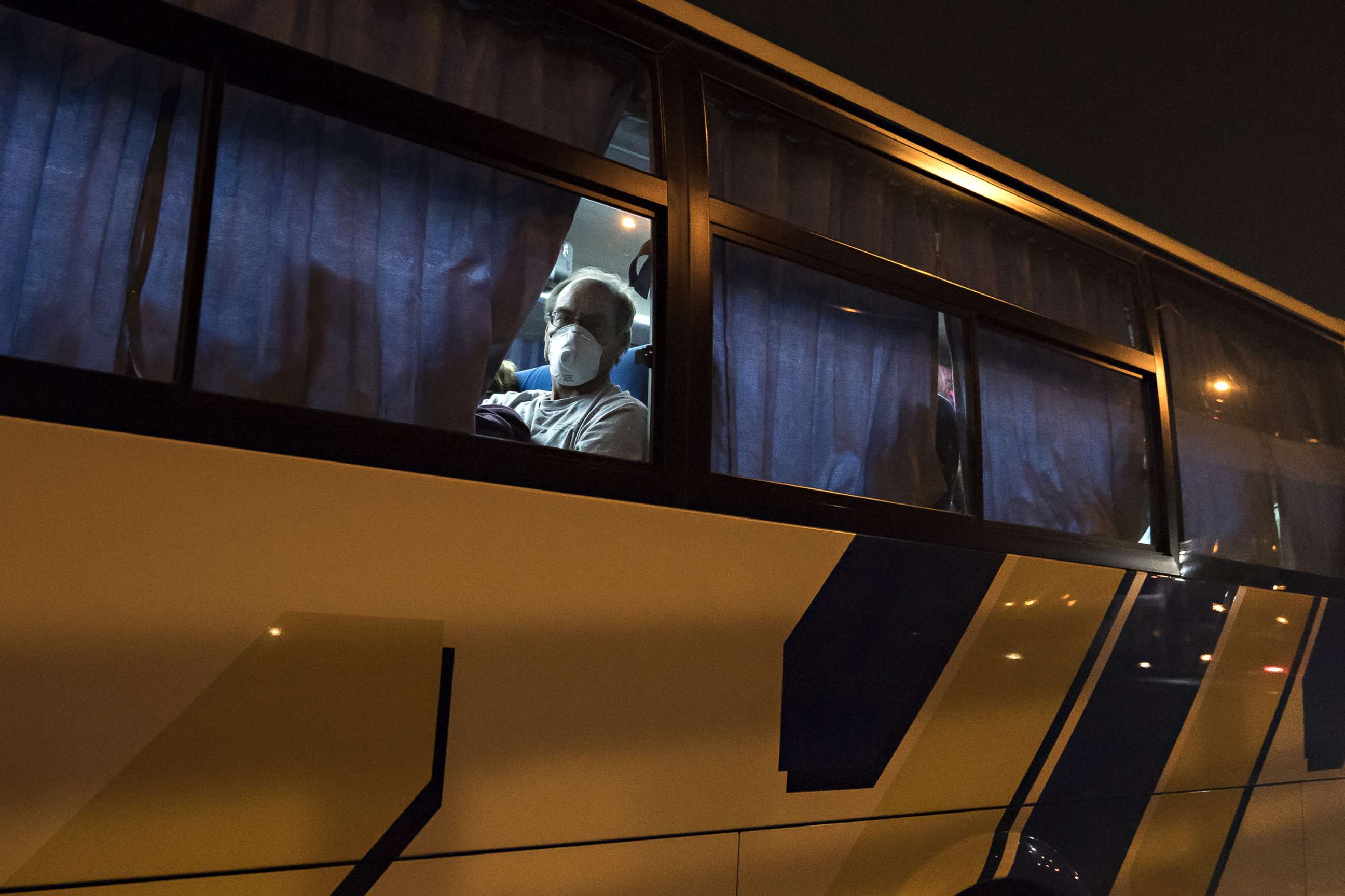 PHOTO: American citizens arrive by bus from the quarantined Diamond Princess cruise ship to Haneda airport on Feb. 17, 2020 in Tokyo to be repatriated to the U.S