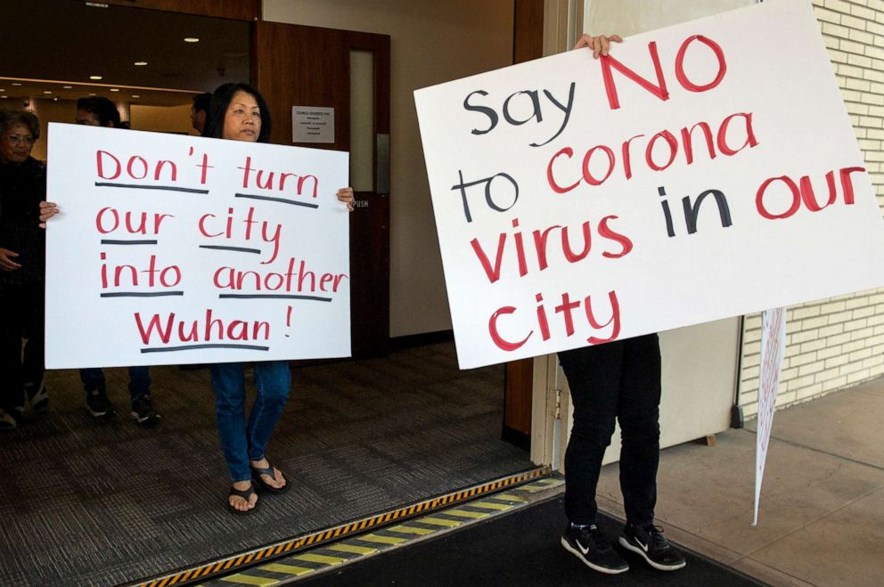 PHOTO: Mary Cahill, left, leaves a news conference where officials discussed the proposal for housing coronavirus patients at the Fairview Development Center in Costa Mesa, Calif on Feb. 22, 2020.
