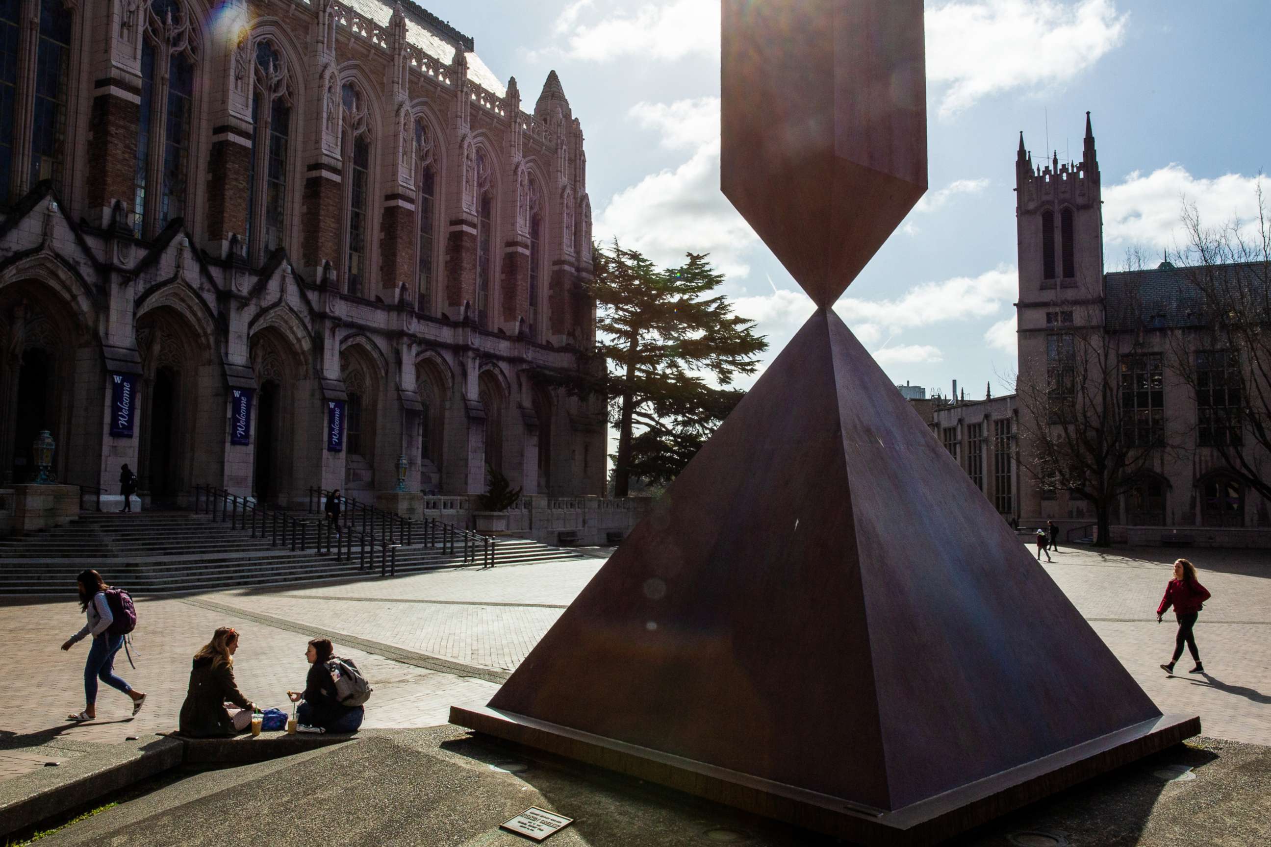 PHOTO: Students walk across the University of Washington campus in Seattle, March 4, 2020. On March 6, the university said it will cancel in-person classes and have students take courses and finals remotely.