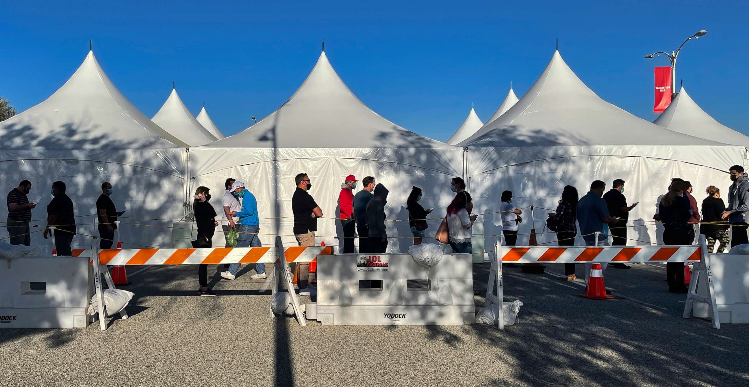 PHOTO: People stand in line for the COVID-19 vaccine outside Pierce College in the Woodland Hills section of Los Angeles, April 7, 2021.