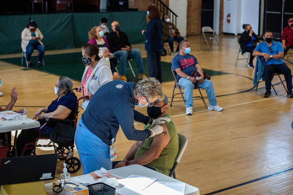 PHOTO: People receive doses of the Moderna COVID-19 vaccine at a mobile vaccination clinic at Saint Charles Borromeo Catholic Church's McGivney community center in Bridgeport, Conn., April 20, 2021.