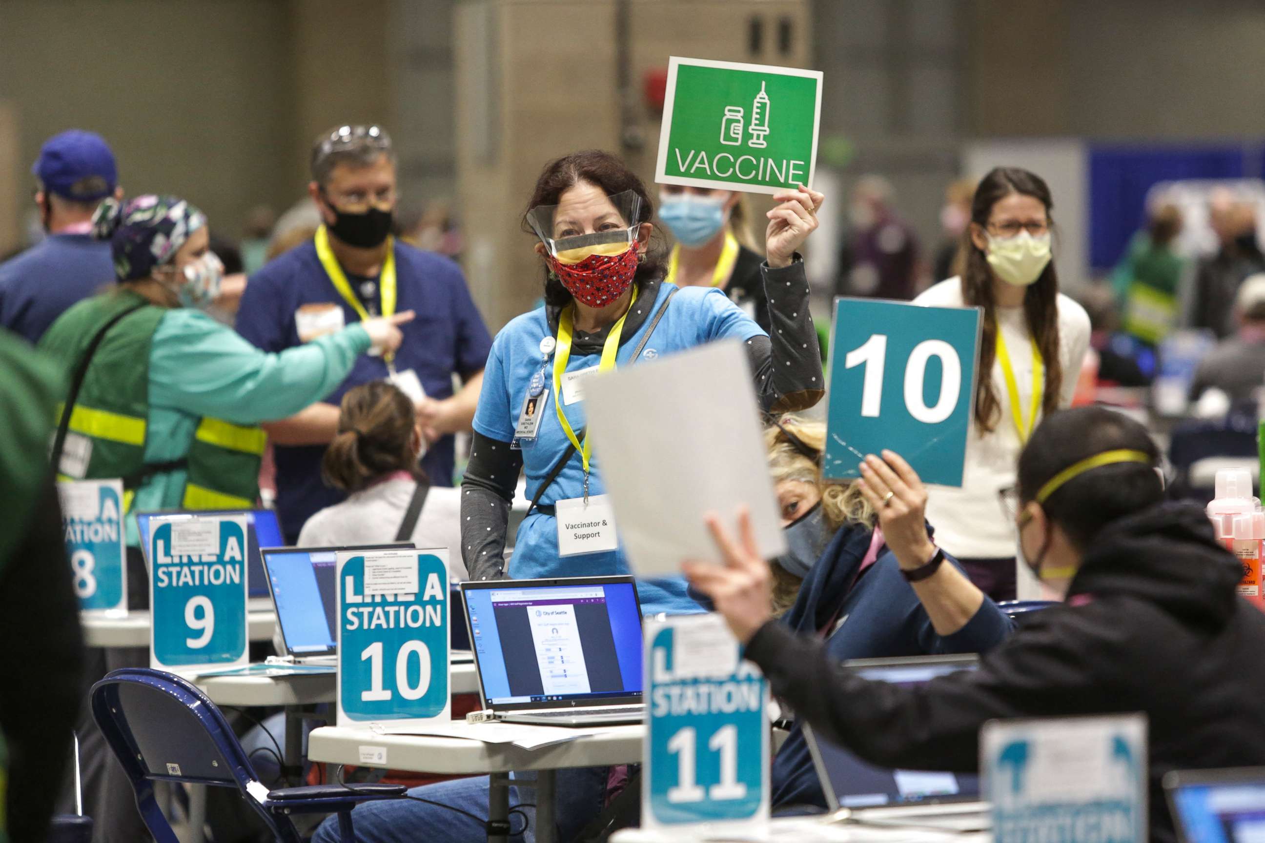 PHOTO: Staff and volunteers work vaccination stations during opening day of the Community Vaccination Site at the Lumen Field Event Center in Seattle, on March 13, 2021.