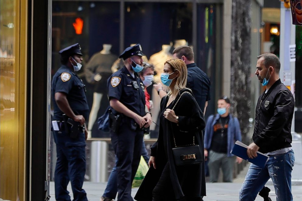 PHOTO: Pedestrians and Police officers wear protective masks during the coronavirus pandemic in Times Square, May 28, 2020, in N.Y.