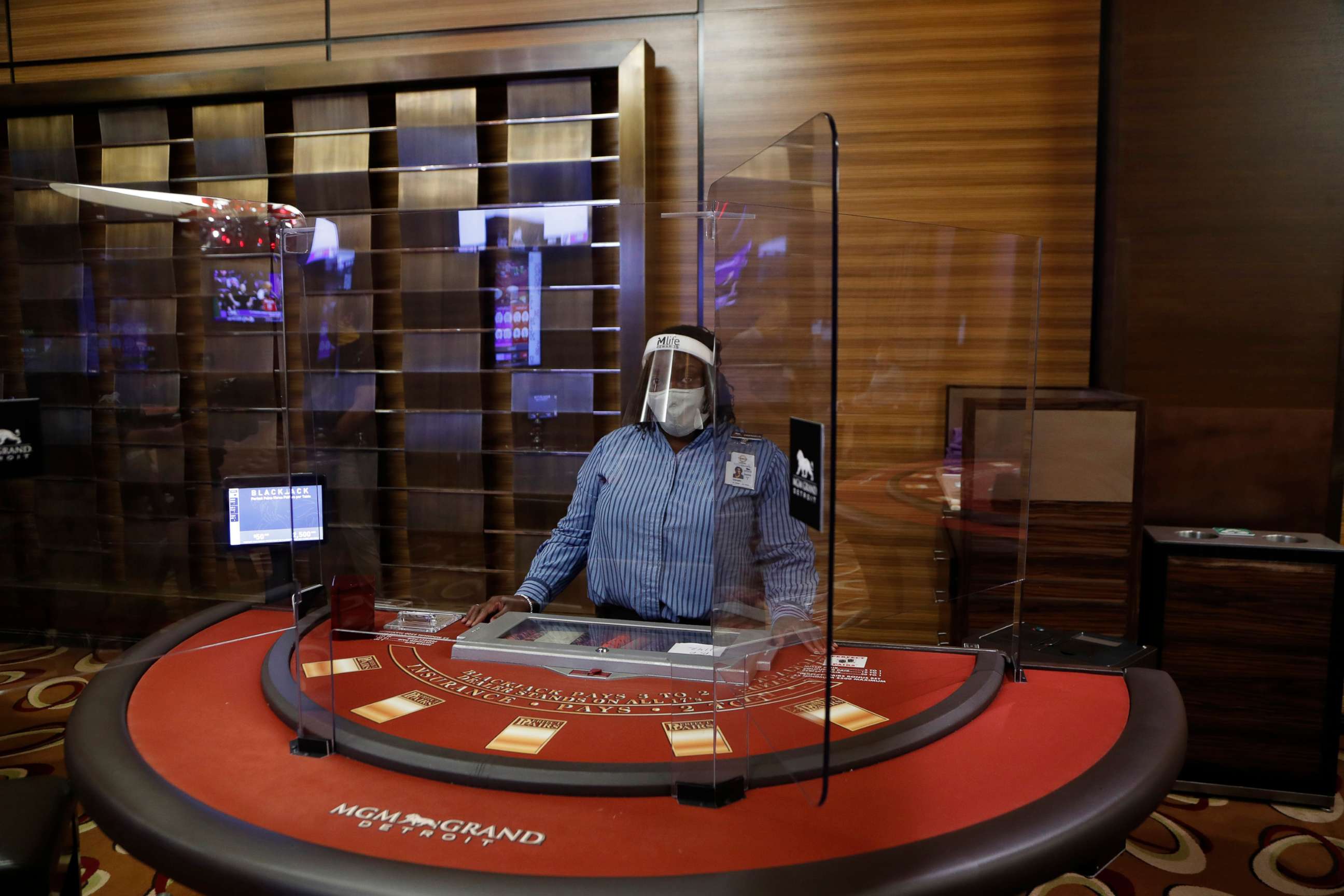 PHOTO: Plexiglass surrounds a blackjack dealer at the MGM Grand Detroit casino, Aug. 5, 2020, in Detroit.