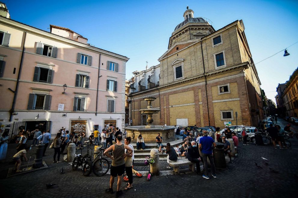 PHOTO: People share a neighborhood outdoors aperitif drink at a square in Rome on May 21, 2020.