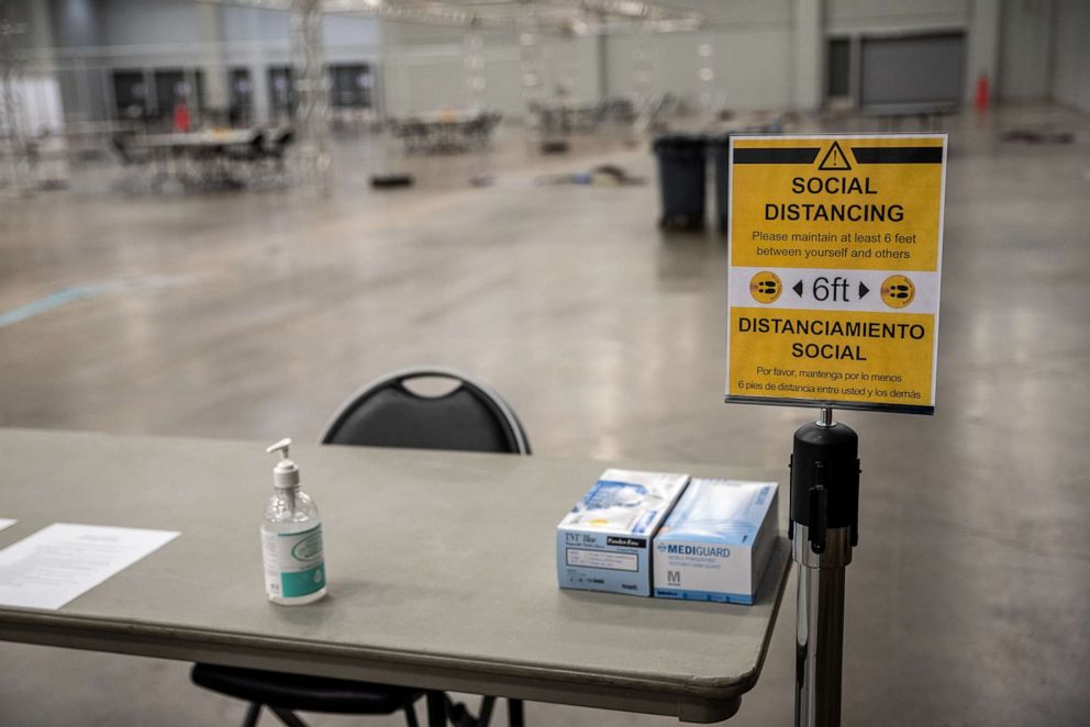 PHOTO: A social distancing sign stands on display at a temporary hospital in the Austin Convention Center in Austin, July 27, 2020. 