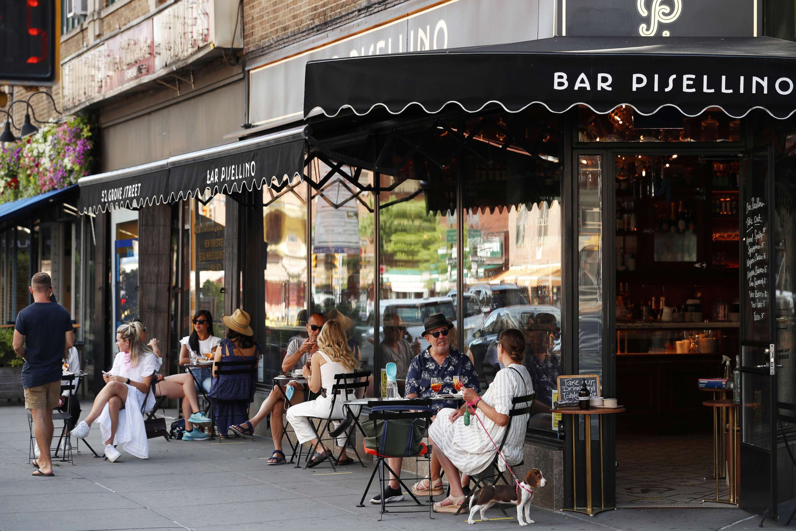 PHOTO: Customers practice social distancing in outdoor seating at seating that follows current health guidelines to slow the spread of Coronavirus (COVID-19) at a restaurant in New York City, June 25, 2020.