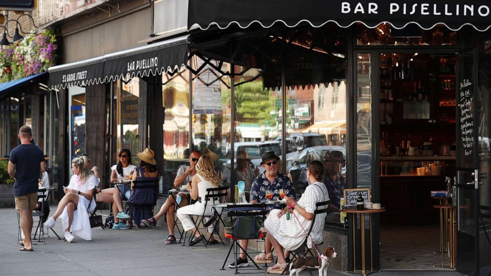 PHOTO: Customers practice social distancing in outdoor seating at seating that follows current health guidelines to slow the spread of Coronavirus (COVID-19) at a restaurant in New York City, June 25, 2020.