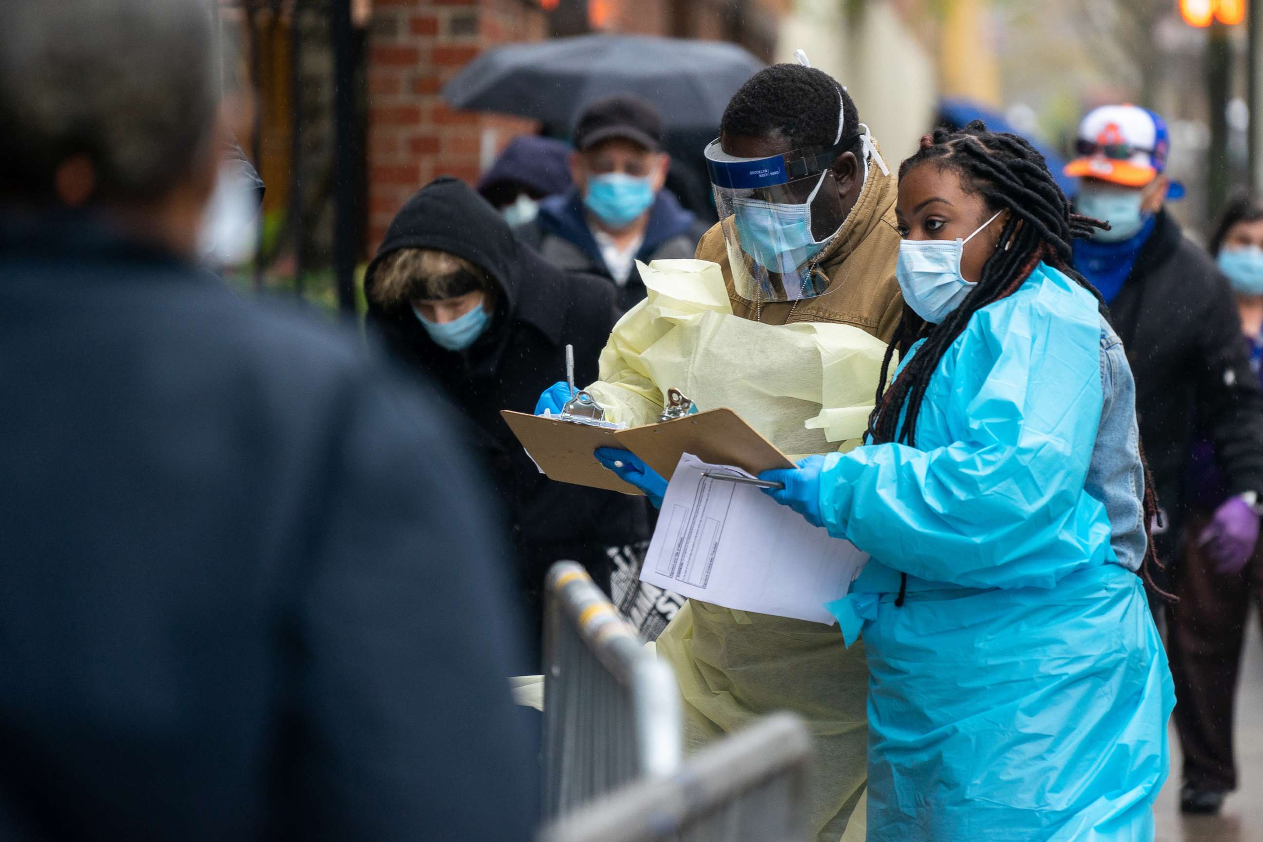 PHOTO: Medical workers assist people standing in line at NYC Health + Hospitals/Gotham Health, waiting to be tested for the coronavirus on April 24, 2020, in New York City.